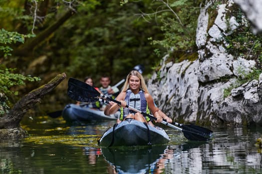 A group of friends enjoying having fun and kayaking while exploring the calm river, surrounding forest and large natural river canyons.