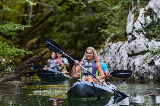 A group of friends enjoying having fun and kayaking while exploring the calm river, surrounding forest and large natural river canyons.