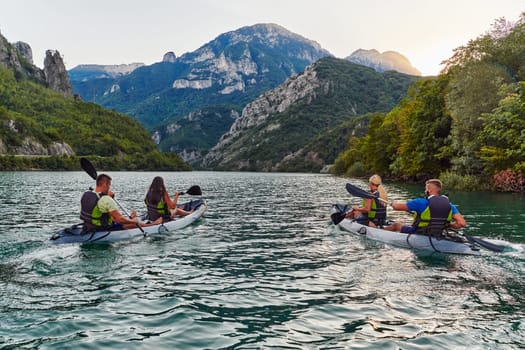 A group of friends enjoying fun and kayaking exploring the calm river, surrounding forest and large natural river canyons during an idyllic sunset