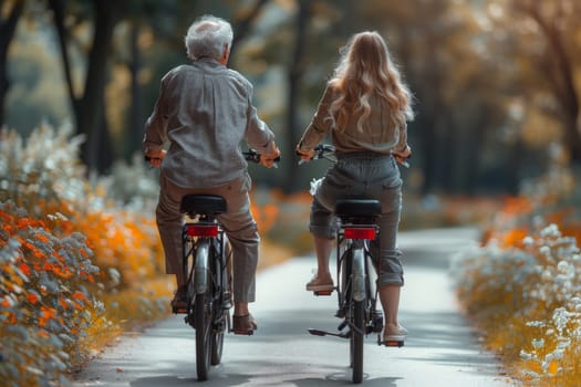 Two fun-loving seniors bike together in the fall to stay fit and healthy. Active elderly couple on bicycles.