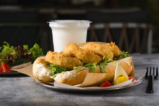 Deep fried squid in bread with greens on the side. Squid sandwich