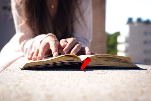 A concentrated Caucasian woman reads a book.