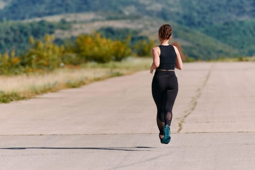 Rain or shine, a dedicated woman powers through her training run, her eyes set on the finish line.