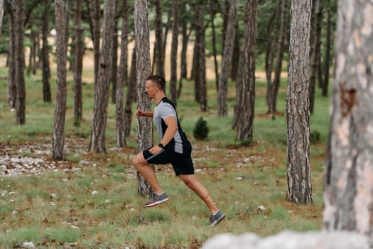 An unwavering man dashes through perilous forest paths, skillfully hurdling over wooden obstacles with determination and agility, epitomizing courage and athleticism