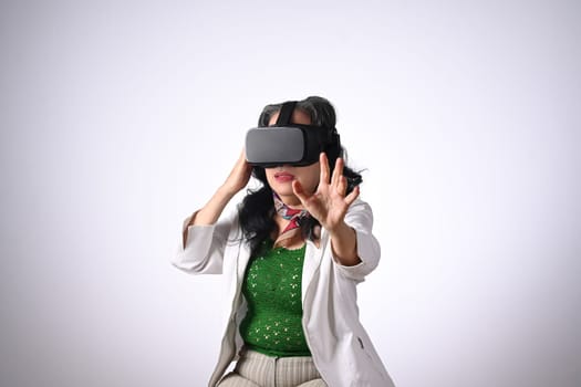 Excited senior woman VR headset enjoying virtual reality experience. Futuristic technology concept.