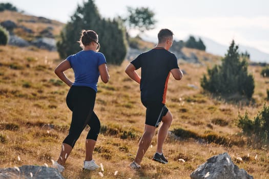 Couple conquer challenging mountain trails during an invigorating morning run.