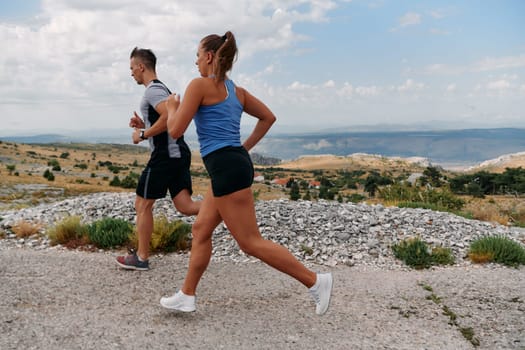 Couple conquer challenging mountain trails during an invigorating morning run.