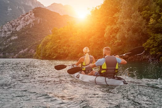 A group of friends enjoying fun and kayaking exploring the calm river, surrounding forest and large natural river canyons during an idyllic sunset