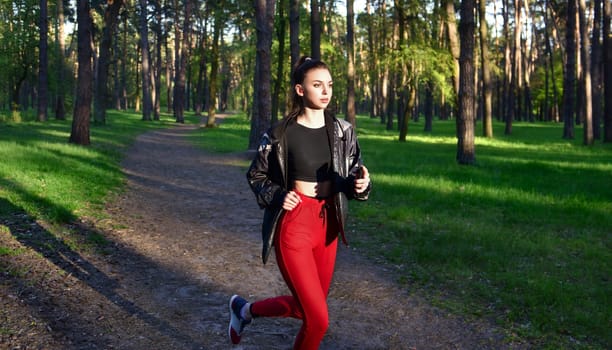 Fitness woman running in the park. Outdoor sports