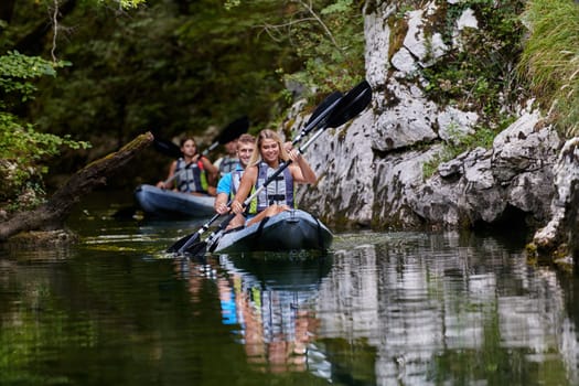 A group of friends enjoying having fun and kayaking while exploring the calm river, surrounding forest and large natural river canyons.