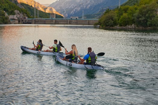 A group of friends enjoying having fun and kayaking while exploring the calm river, surrounding forest and large natural river canyons.