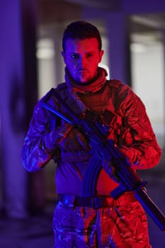 A professional soldier undertakes a perilous mission in an abandoned building illuminated by neon blue and purple lights.