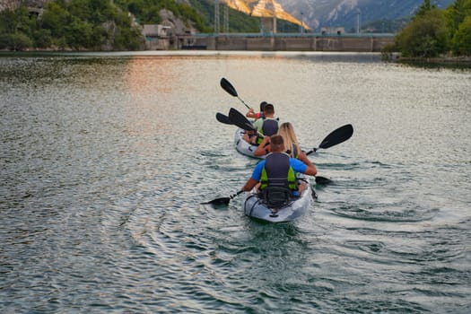 A group of friends enjoying having fun and kayaking while exploring the calm river, surrounding forest and large natural river canyons.