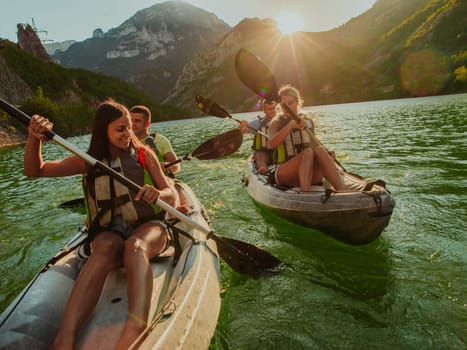 A group of friends enjoying fun and kayaking exploring the calm river, surrounding forest and large natural river canyons during an idyllic sunset