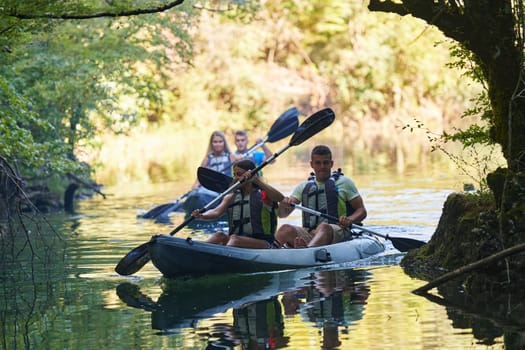 A group of friends enjoying having fun and kayaking while exploring the calm river, surrounding forest and large natural river canyons.