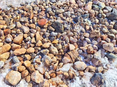 Small pebbles in the snow as background and texture. Heart-Shaped Rock Arrangement on Wall. Background, texture, pattern, frame, copy space