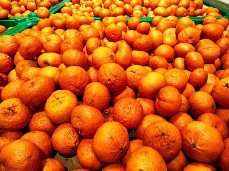 A Multitude of Fresh Oranges on Display at a Market Stall. Piles of vibrant oranges creating colorful texture in a market