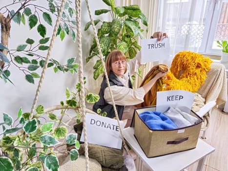 Middle-Aged Woman Sorting Belongings With KonMari Method. Mature woman categorizes items into keep and discard piles