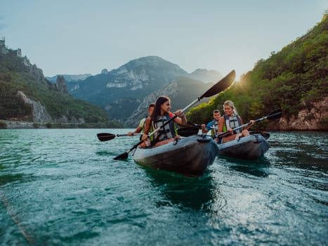 A group of friends enjoying fun and kayaking exploring the calm river, surrounding forest and large natural river canyons during an idyllic sunset