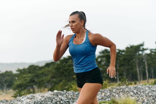 Rain or shine, a dedicated woman powers through her training run, her eyes set on the finish line.