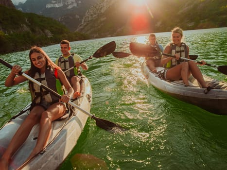 A group of friends enjoying fun and kayaking exploring the calm river, surrounding forest and large natural river canyons during an idyllic sunset