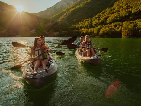 A group of friends enjoying fun and kayaking exploring the calm river, surrounding forest and large natural river canyons during an idyllic sunset