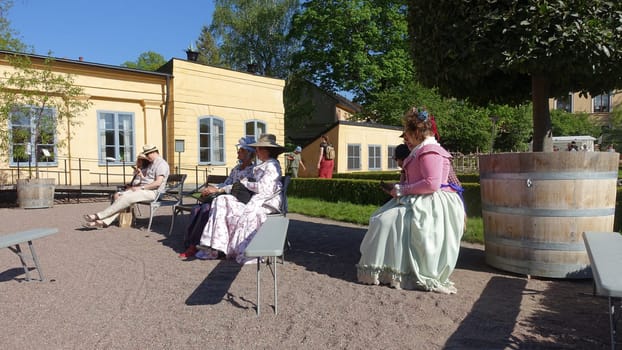 Uppsala, Sweden, May 18, 2024. A day at the Linnaeus Garden Party. 1700s theme. Sitting.