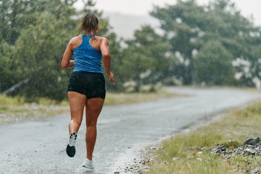 Rain or shine, a dedicated woman powers through her training run, her eyes set on the finish line.