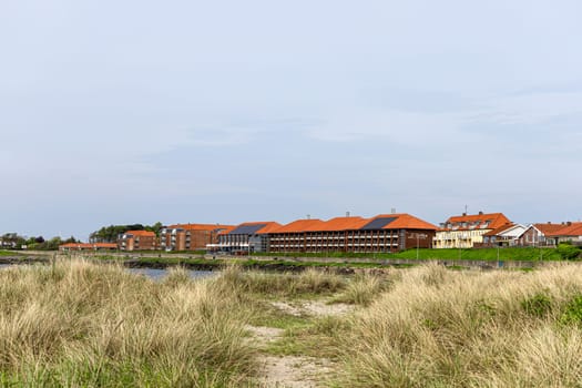 Beautiful natural beach with sand and grass in the town of Ronne on the Bornholm Island, Denmark.