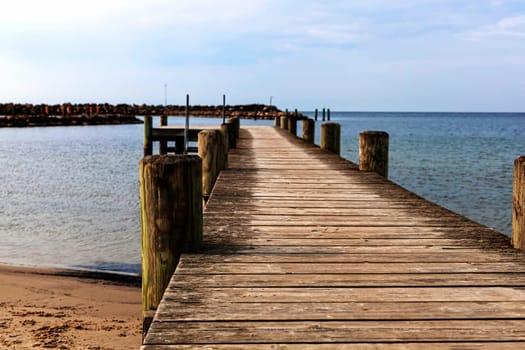 Long wooden pier on the sea. Beautiful landscape view.