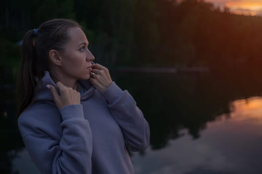 Woman sitting on the pier, closeup portrait, beauty summer sunset