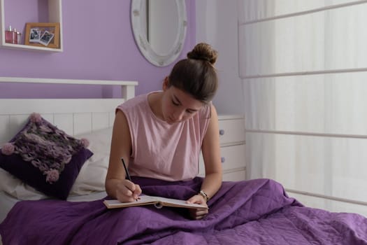 Close up picture of a teenager taking notes in her notebook .Horizontal pictures.