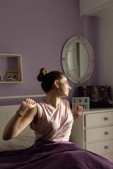 Teenager in her room awakening with the sun on her face.