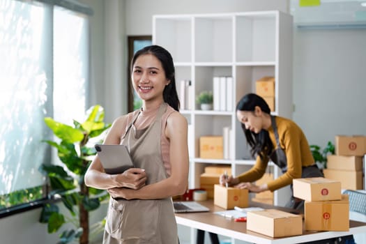 Entrepreneur startup business woman sme holding tablet. Small Online Business Owner, Online Marketing and Product Packing and Delivery Service. E-commerce concept.