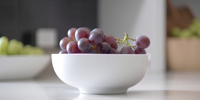 Blue grapes bowl on the kitchen table with blurred background