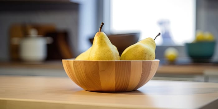 Pears in a bowl on the kitchen table on a blurred background