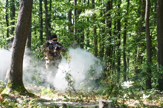 A specialized military antiterrorist unit conducts a covert operation in dense, hazardous woodland, demonstrating precision, discipline, and strategic readiness.