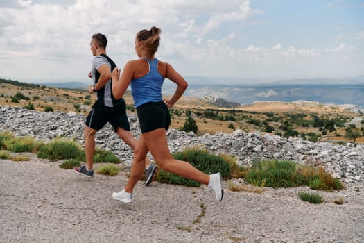 Couple conquer challenging mountain trails during an invigorating morning run.