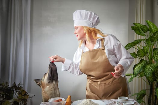 Fat funny female cook in a hat and apron in the kitchen with big shepherd dog. Good cooking, body positive, pet