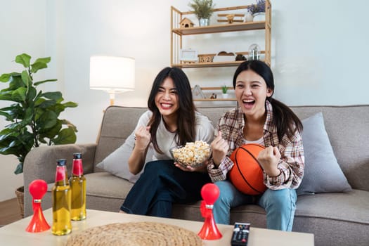 LGBT Soccer or Sport fans emotionally watching game in the living room.