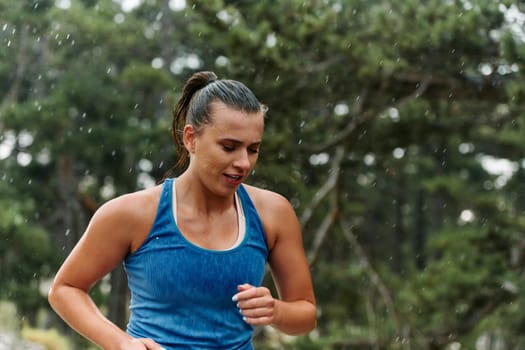 Rain or shine, a dedicated woman powers through her training run, her eyes set on the finish line.