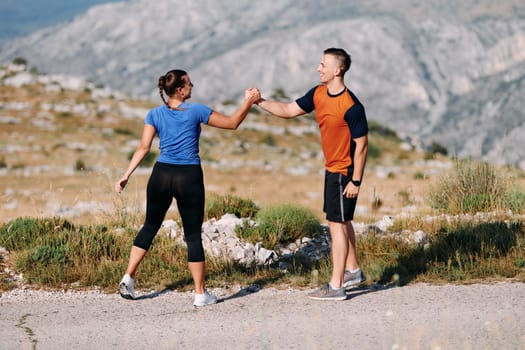 A jubilant couple celebrates their triumphant finish after a challenging morning run, exuding happiness and unity amidst the refreshing outdoor scenery.