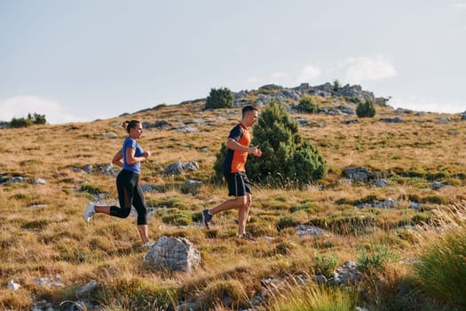 Couple conquer challenging mountain trails during an invigorating morning run.