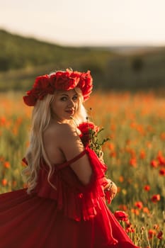 A woman in a red dress is standing in a field of red flowers. The scene is serene and peaceful