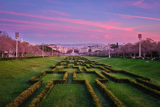 View of Lisbon Marquis of Pombal Square seen from the Eduardo VII Park in the evening twilight. Lisbon, Portugal