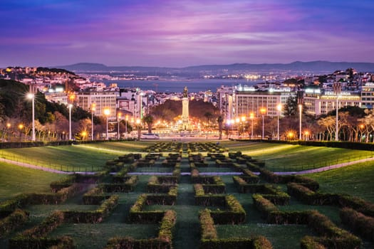 View of Lisbon Marquis of Pombal Square seen from the Eduardo VII Park in the evening twilight. Lisbon, Portugal