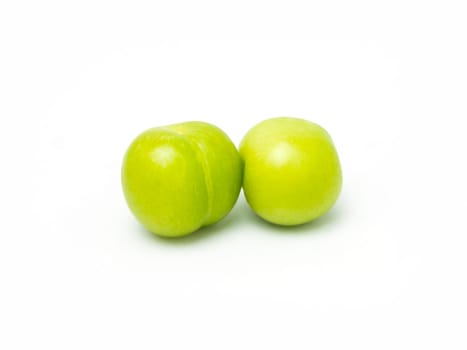 pair of fresh green plums isolated on white background. High quality photo