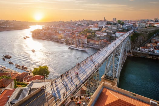 View of Porto city and Douro river and Dom Luis bridge I from famous tourist viewpoint Miradouro da Serra do Pilar on sunset. Porto, Vila Nova de Gaia, Portugal