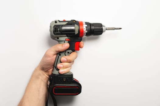 Male hand holding a screwdriver on a white background studio shot copy space.