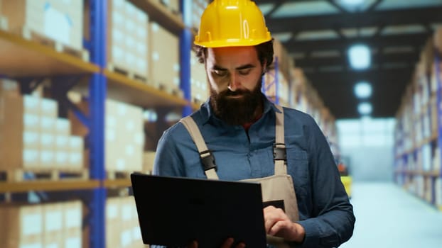 Depot engineer verifying cargo labels and boxes, ensuring shipment and delivery correct details. Warehouse supervisor responsible for staff management and industrial retail activities.